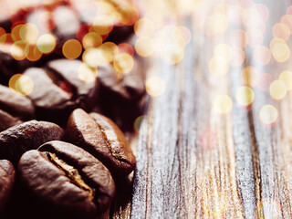 Coffee beans on a wooden background close-up. copy space. bokeh selective focus