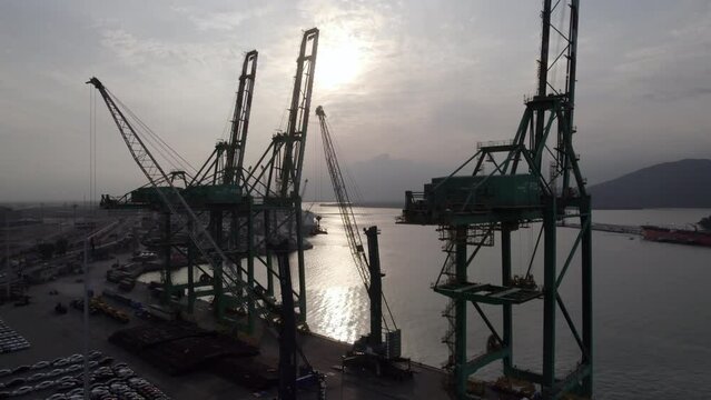 Aerial view of shipping port at sunset on overcast day