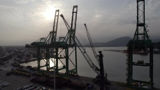 Shipping port with empty cranes and no transport ships on overcast day