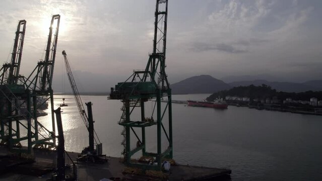 Containership cranes at empty shipping port - rotating aerial view