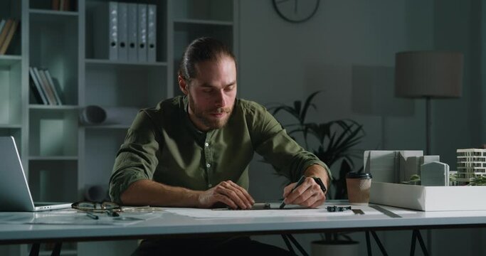 Portrait of an young male engineer working on a project at his office.