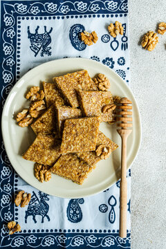 Overhead view of a plate of traditional Georgian honey and walnut brittle (gozinaki) on a  traditional tablecloth