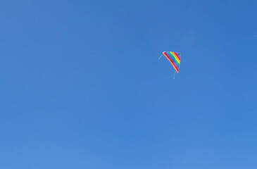 flying rainbow kite in the blue sky