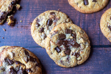 freshly baked homemade chocolate chip cookies on wooden background.