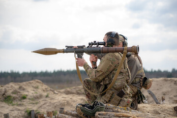 A soldier fires a grenade launcher
