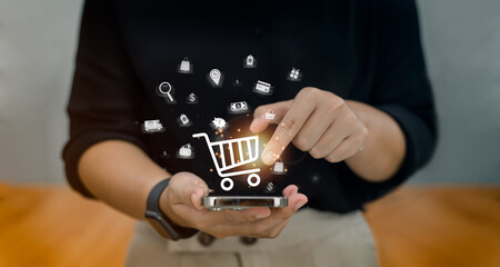 Ladies use mobile to input orders with credit card delivery for online shopping and e-commerce technology concepts.
