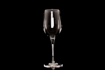 One crystal wine glass, macro, isolated on black background.
