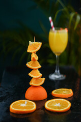 Stacked orange slices with juice on the background, Creative fruits photography image, fresh and healthy juice image