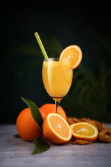 Orange juice in a beautiful juice glass with sliced orange fruits