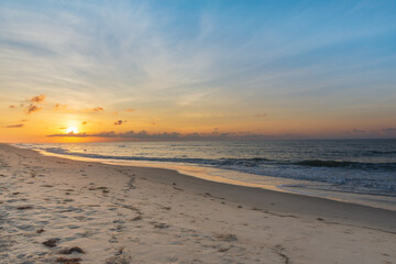 Sunrise over the white sand of Ocracoke Island and the Atlantic Ocean.