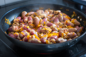 Chicken hearts stew with vegetables in pan