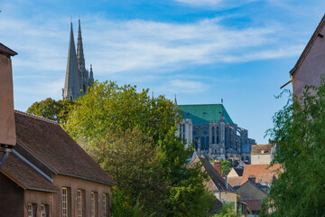 The Notre-Dame de Chartres Cathedral is seen from below framed by the ancient homes of the town of...
