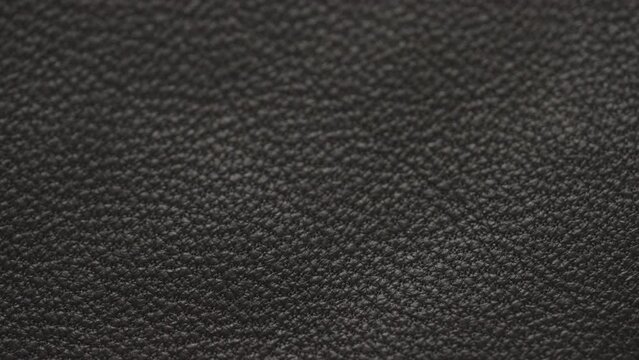 Slow motion handheld shot of soft gray brown leather closeup