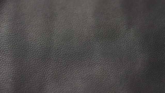 Slow motion handheld shot of soft gray brown leather closeup