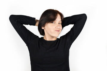 A teenage girl on a white background is happy and very positive, makes funny faces, girl is just happy because vacations and summer camps are coming soon