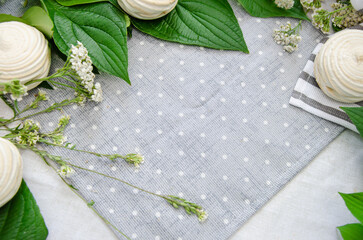 Meringue homemade zephyr marshmallow and season herbs on cotton grey dotted tablecloth. Mockup card. Template for recipes or food menu