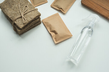 Kit for growing microgreens at home. Seeds, linen growing mat and water sprinkler on the white background.