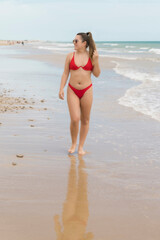 Fototapeta na wymiar Happy young beautiful woman on the beach 