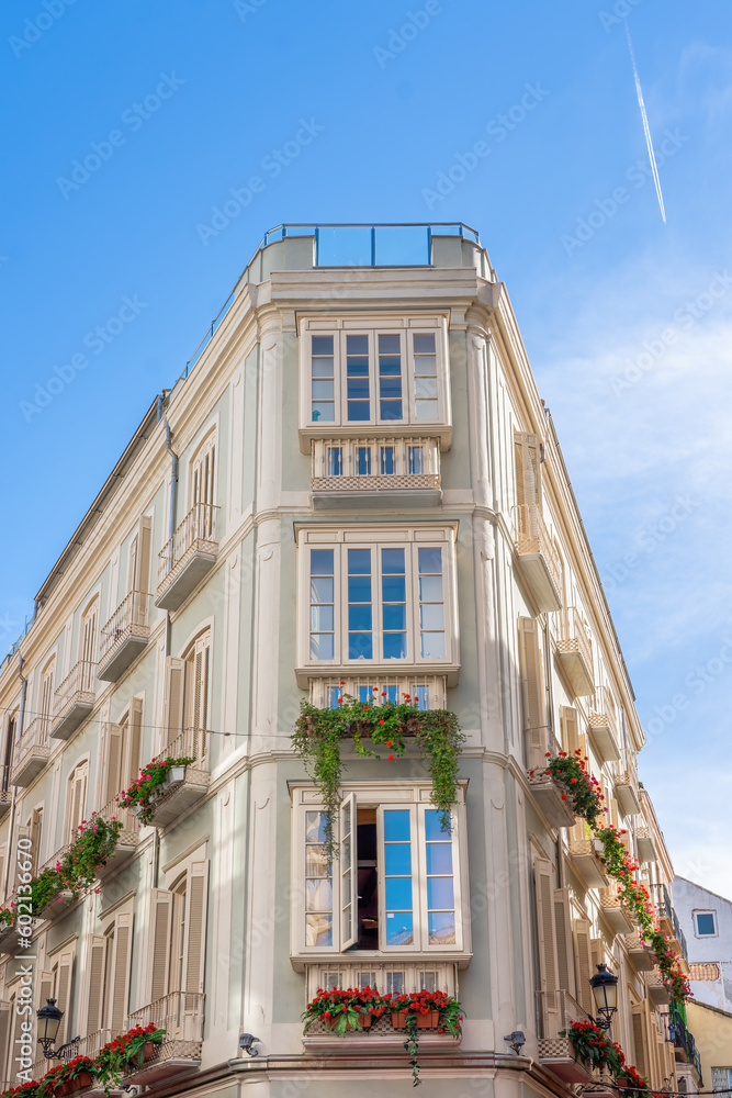 Sticker building with flower window boxes - malaga, andalusia, spain