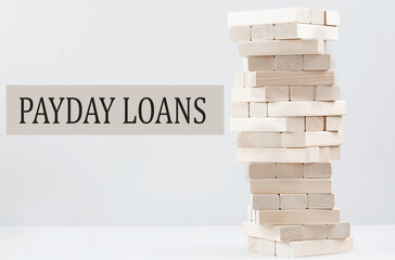 PAYDAY LOANS text with wooden block stack on white background , business concept