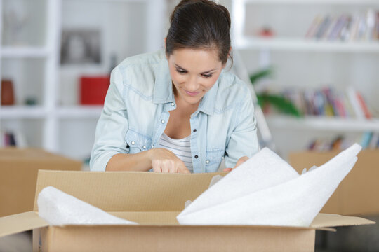 Young Woman Packing A Box