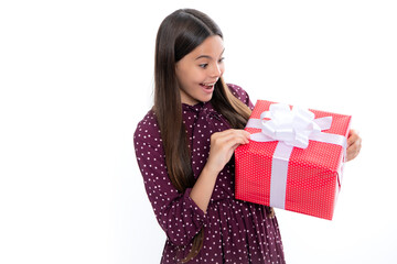 Emotional teenager child hold gift on birthday. Funny kid girl holding gift boxes celebrating happy New Year or Christmas. Portrait of emotional amazed excited teen girl.