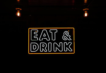 Eat and Drink neon sign with vintage lightbulbs and ceiling