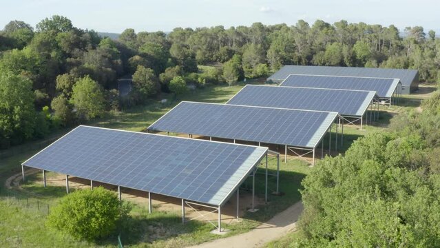 Aerial shot of a small solar panel farm in the heart of the forest