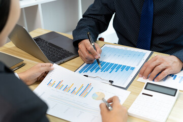 Businessman explaining in detail information from graph chart
