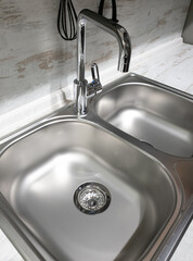 Two sinks and a faucet in the kitchen