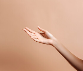 Female hand on beige background.