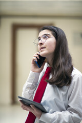 businesswoman talking by phone in office, working with tablet