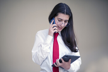 businesswoman talking by phone in office, working with tablet
