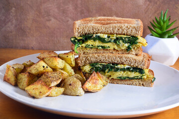 scrambled egg and spinach sandwich  with home fries