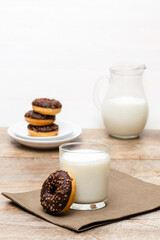 Mini donuts with chocolate glaze served with glass of milk.tasty sweet creamy doughnuts dessert food