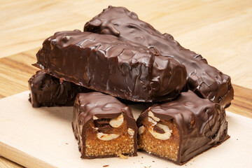 Snickers, a homemade dessert made from natural products on a wooden board. 