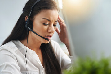 Call center, face or woman with headache, stress or burnout is overworked by telemarketing deadline. Depressed, sad or tired sales agent frustrated with migraine pain in customer services office