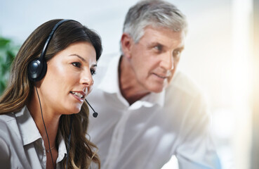 Coaching, woman or senior manager in call center training telemarketing in customer services office. Contact us, coaching or mature mentor teaching an insurance agent on new job advice on computer