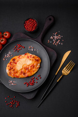 Grilled chicken fillet in the form of a steak with tomatoes, pineapple and cheese