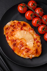 Grilled chicken fillet in the form of a steak with tomatoes, pineapple and cheese