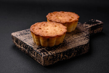 Delicious baked cupcake or tartlet with cheese and raisins