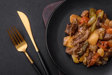Delicious stew with potatoes, tomatoes, beef, onions and carrots
