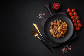 Delicious stew with potatoes, tomatoes, beef, onions and carrots