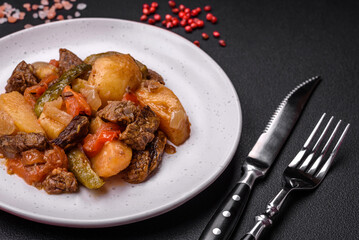 Delicious stew with potatoes, tomatoes, beef, onions and carrots