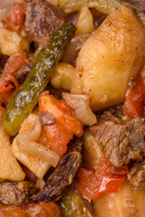 Delicious stew with potatoes, tomatoes, beef, onions and carrots
