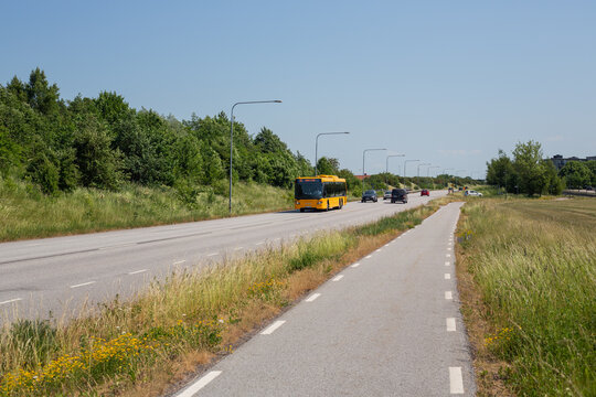 Yellow bus on road with bike lane in Malmo, Sweden
