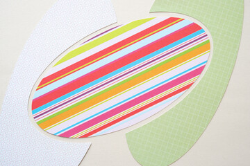 whimsical ovoid shapes cut from striped scrapbook paper using a machine