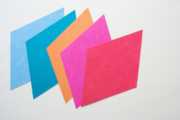 diamond or rhombus paper shapes machine-cut from colored paper cards