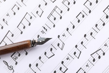 Sheet with musical notes and fountain pen, top view