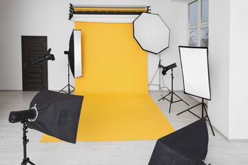 Interior of modern photo studio with professional lighting equipment